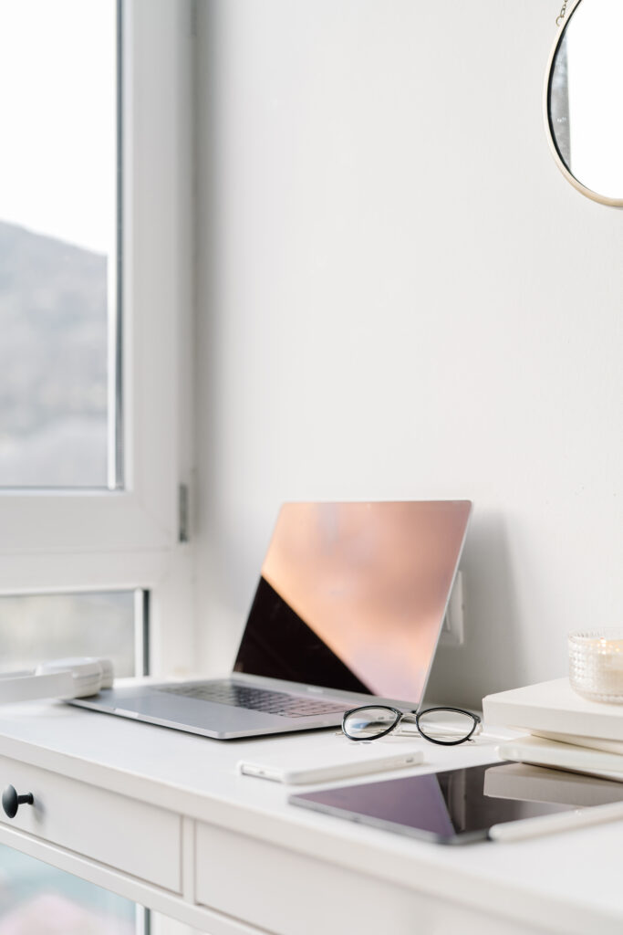 Flat lay of a wedding planner’s workspace with laptop, notebook, and coffee — representing starting a wedding planning business with no money