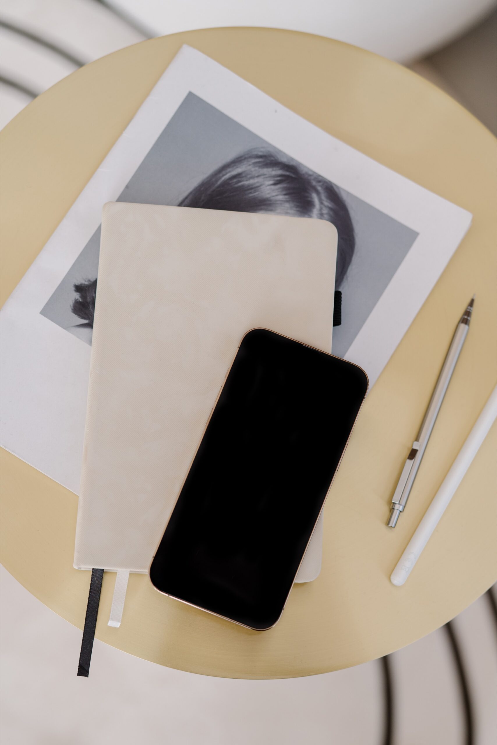 A tablet or laptop sits open displaying a Pinterest board of wedding mood inspiration — soft florals, neutral color palettes, venue shots.