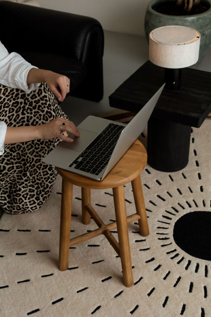 Wedding pro at her desk batching Pinterest content with multiple pin designs and a scheduling tool on screen